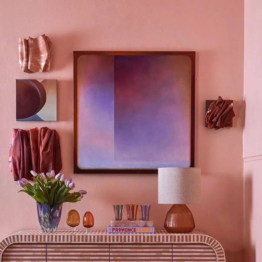 A plum and copper geometric painting by Michele Luminato, styled on a gallery wall